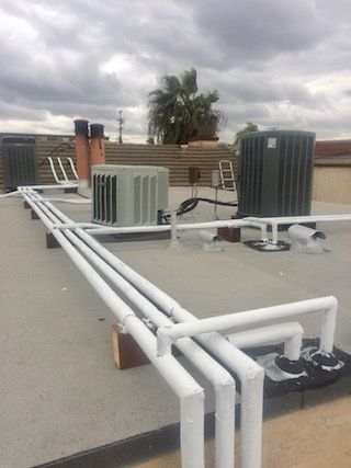 Rooftop repipe lines on a condo building